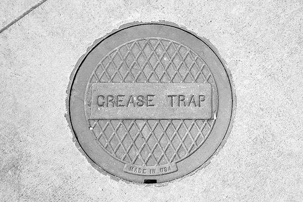 foul odors, slow drainage, and grease overflowing are all signs that a grease trap needs grease trap pumping